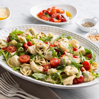 Spinach & Ricotta Tortelloni Salad with Cherry Tomatoes, Arugula & Pine Nuts