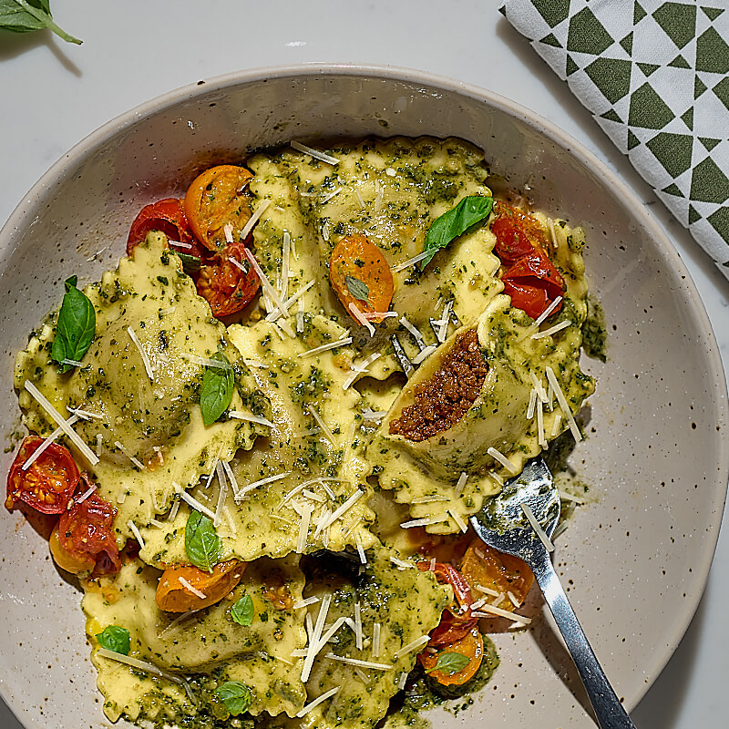 Ravioli with Pesto and Roasted Tomatoes featuring Impossible™ Italian Sausage Made From Plants